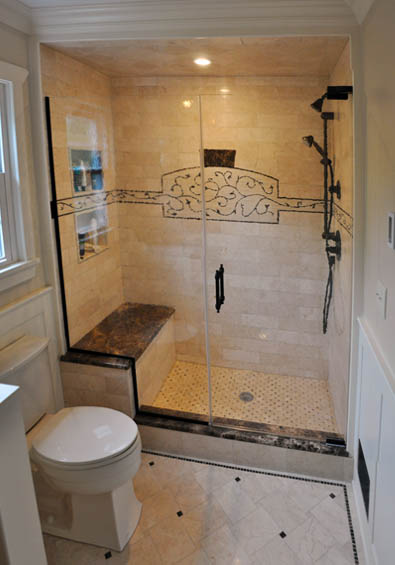 Custom glass tile mosaic installed in a marble shower